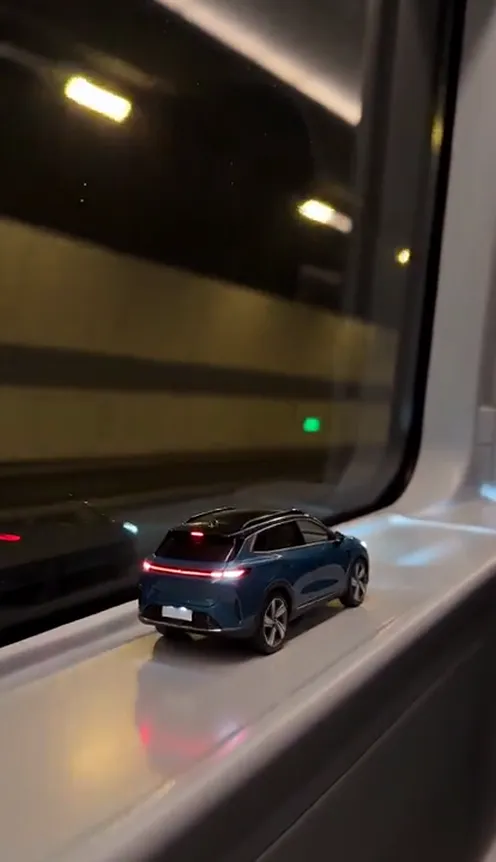 A toy model of a car on a train window ledge turning into the real car in a tunnel